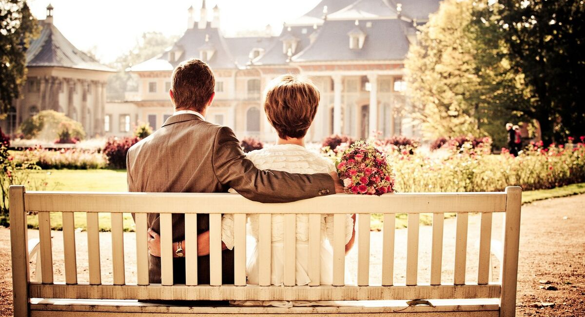 Wedding Loans | married couple sitting on a bench reflecting