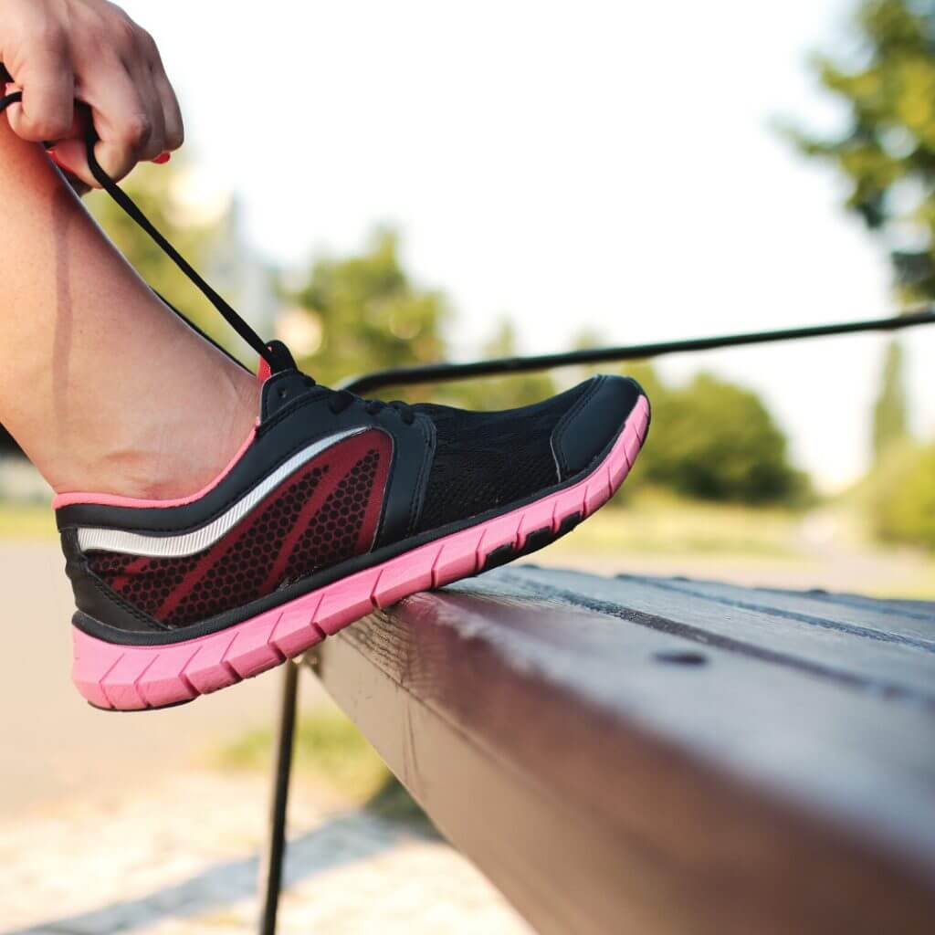 person fastening shoe laces