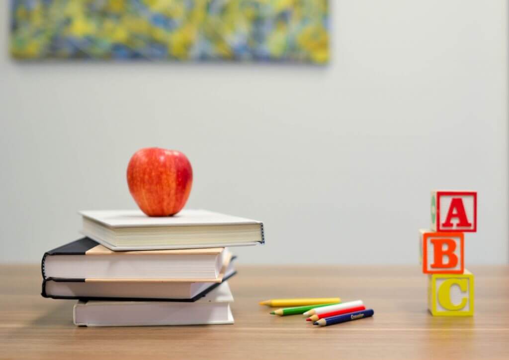 teachers desk with apple and building blocks